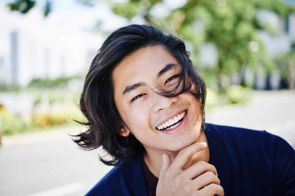 Smiling man with dark hair and mustache | Nudera Orthodontics