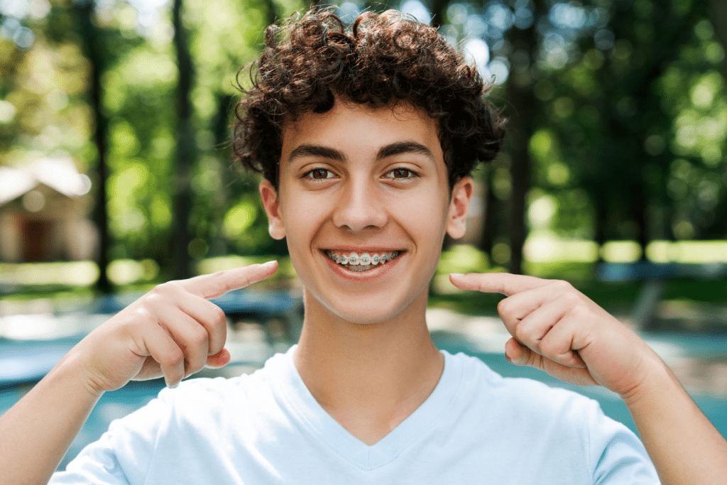 Teen with braces smiling outdoors while planning summer activities in Rockford, IL