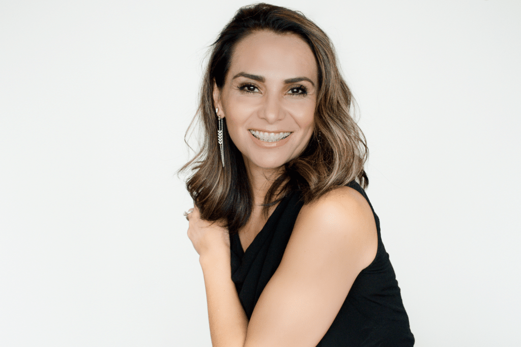 Adult woman smiling while wearing clear ceramic braces